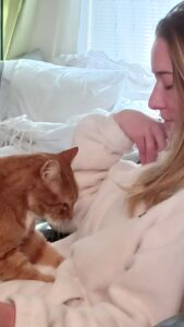 Human with her orange cat
