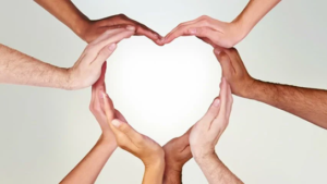 Several hands joined to create heart shape