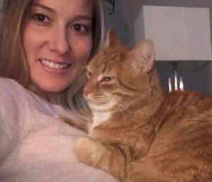 picture of woman with orange cat